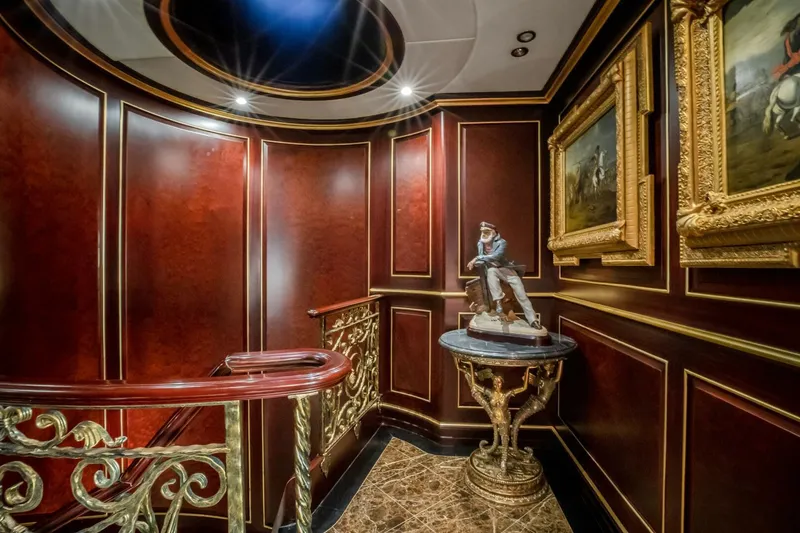 Slide: The Image of Luxurious yacht interior with elegant wood paneling, ornate staircase, and classic artwork, Horizon Model Tri-Deck 2009. - 20