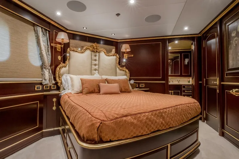 Slide: The Image of Luxurious bedroom interior on 2009 Horizon Model Tri-Deck yacht with elegant wood paneling. - 31