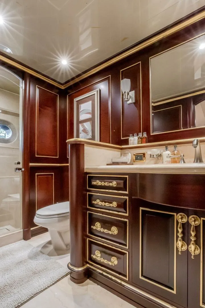 Slide: The Image of Luxurious yacht bathroom with elegant wood cabinetry, gold accents, and modern fixtures, Horizon Model Tri-Deck 2009. - 32