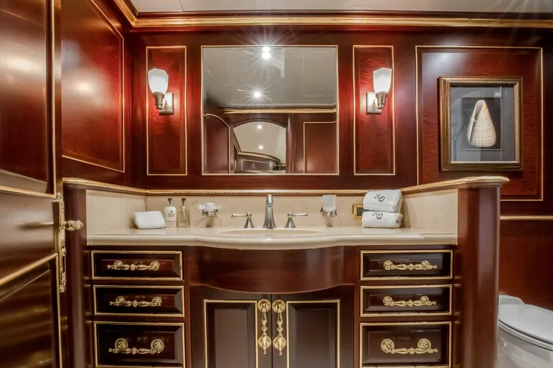 Slide: The Image of Luxurious yacht bathroom with elegant wood cabinetry, gold accents, and modern fixtures, Horizon Model Tri-Deck 2009. - 35