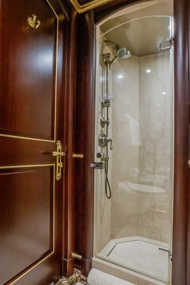 Slide: The Image of Luxurious shower in 2009 Horizon Model Tri-Deck yacht with elegant wood and gold accents. - 41