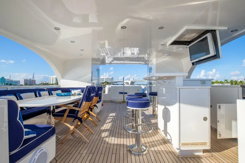 Slide: The Image of Luxurious 2009 Horizon Model Tri-Deck yacht interior with seating, bar stools, and TV. - 47