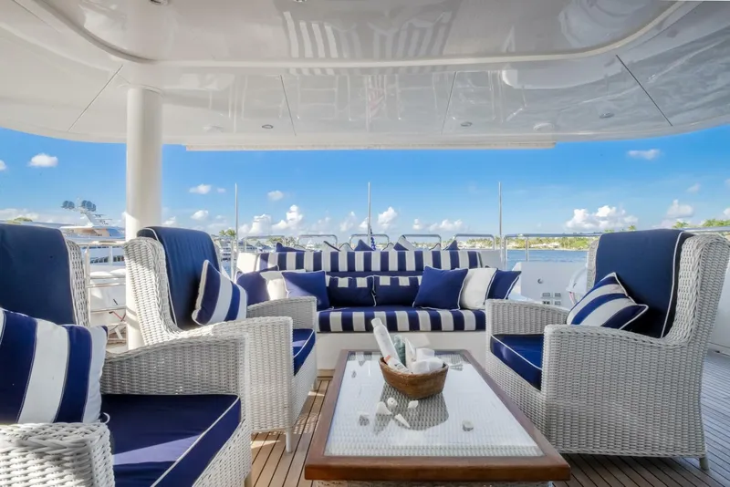 Slide: The Image of Luxurious 2009 Horizon Model Tri-Deck yacht deck with elegant blue and white seating. - 48