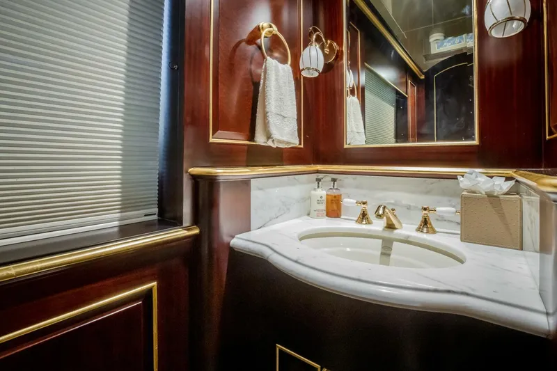 Slide: The Image of Luxurious yacht bathroom with marble sink, gold fixtures, and elegant wood paneling, Horizon Model Tri-Deck 2009. - 9