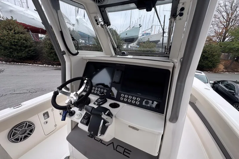 Slide: The Image of Cockpit of 2025 Solace 30 HCS boat with modern steering and control panel. - 12