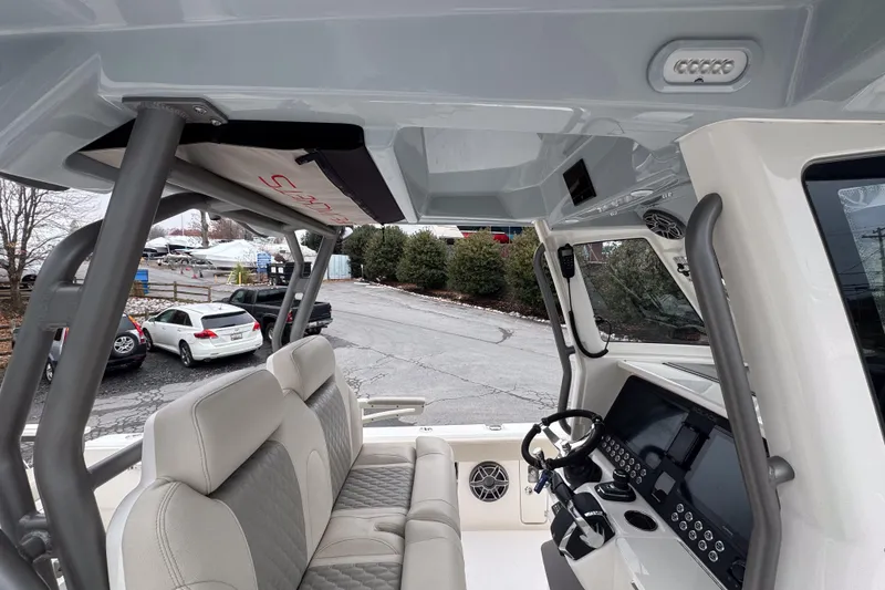 Slide: The Image of Interior view of 2025 Solace 30 HCS boat, featuring modern helm and seating. - 13