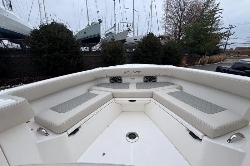 Slide: The Image of 2025 Solace 30 HCS boat interior with cushioned seating and sleek design. - 15