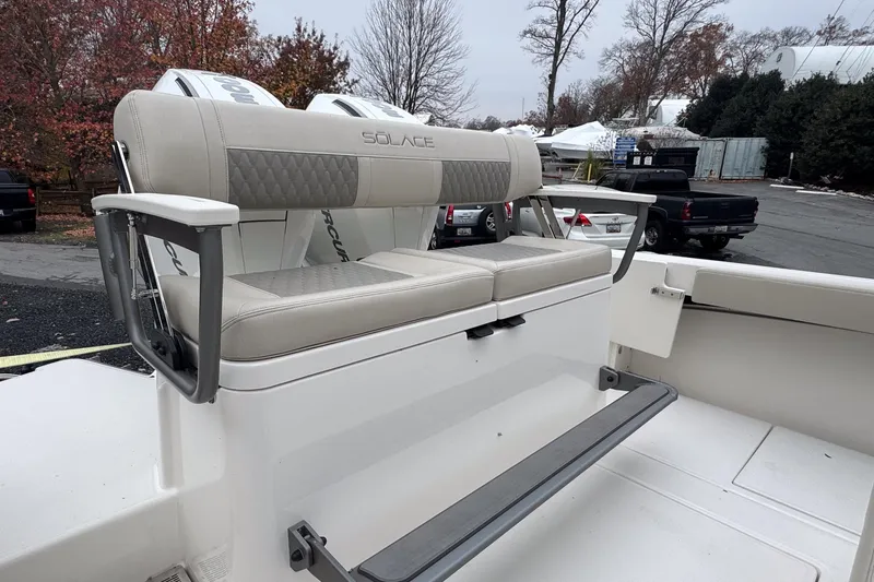 Slide: The Image of 2025 Solace 30 HCS boat seating with armrests, outdoor setting. - 8