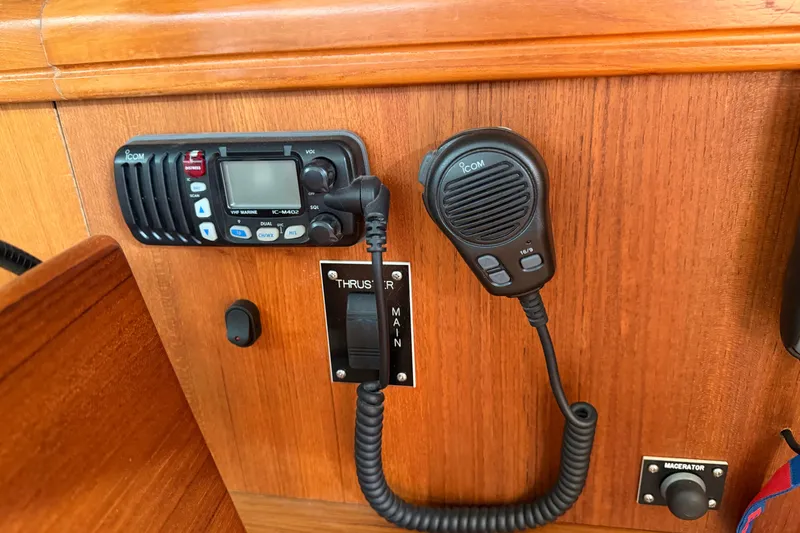 Slide: The Image of Control panel of a 2003 Hunter 44 Deck Salon with radio and thruster controls. - 23