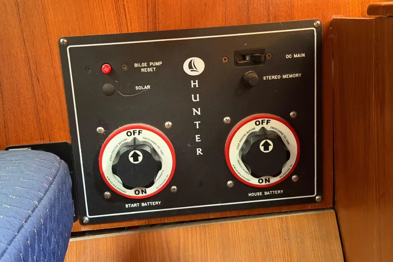 Slide: The Image of Control panel of a 2003 Hunter 44 Deck Salon sailboat with battery switches. - 24