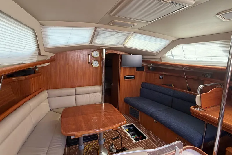 Slide: The Image of Interior of 2003 Hunter 44 Deck Salon yacht with wood finish and seating area. - 29
