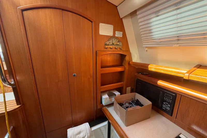Slide: The Image of Interior of 2003 Hunter 44 Deck Salon with wooden cabinetry and countertop. - 30