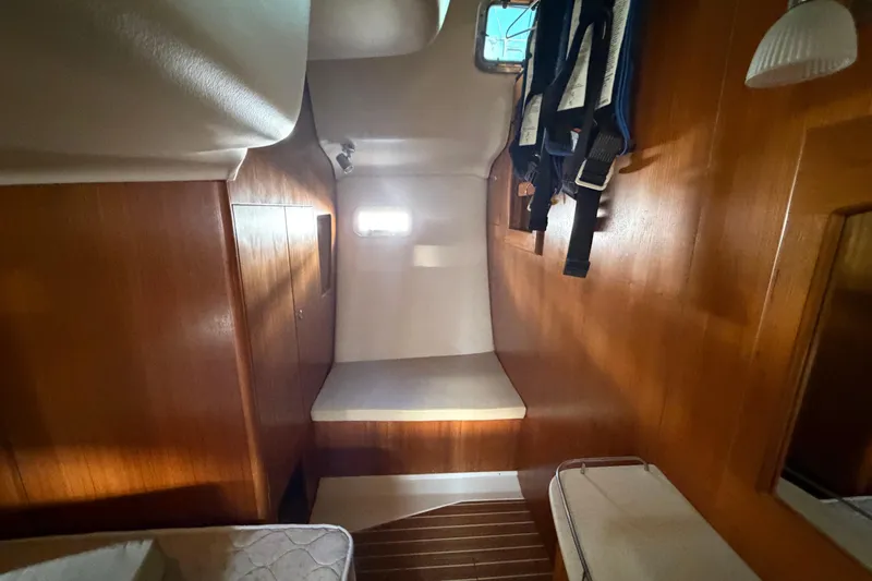 Slide: The Image of Interior cabin of 2003 Hunter 44 Deck Salon yacht with wooden paneling. - 33
