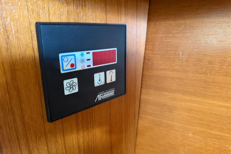 Slide: The Image of Control panel on 2003 Hunter 44 Deck Salon yacht, mounted on wooden surface. - 39