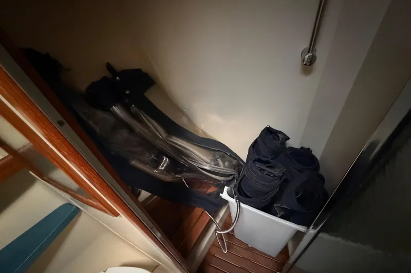 Slide: The Image of Storage area in 2003 Hunter 44 Deck Salon with rolled sails and equipment. - 43