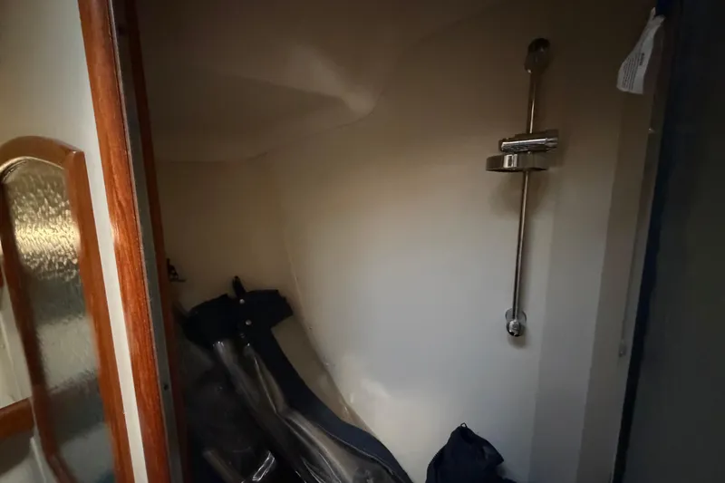 Slide: The Image of Interior of 2003 Hunter 44 Deck Salon, featuring a compact storage area with a metal rail. - 44