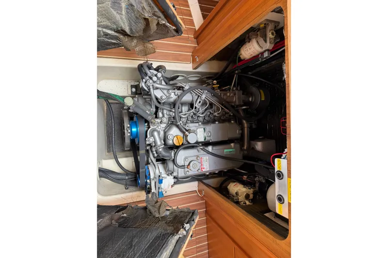 Slide: The Image of Engine compartment of a 2003 Hunter 44 Deck Salon sailboat, showcasing mechanical components. - 47