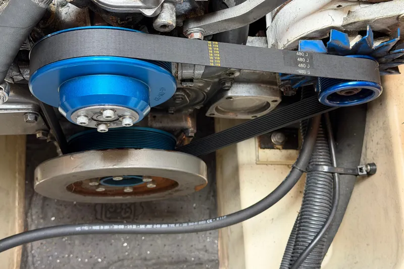 Slide: The Image of Engine belt system of a 2003 Hunter 44 Deck Salon sailboat, featuring blue pulleys. - 49