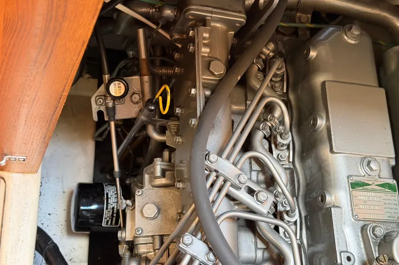 Slide: The Image of Engine compartment of a 2003 Hunter 44 Deck Salon sailboat, showcasing mechanical components. - 50