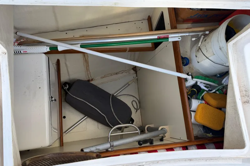 Slide: The Image of Storage compartment of 2003 Hunter 44 Deck Salon with cleaning supplies and equipment. - 59