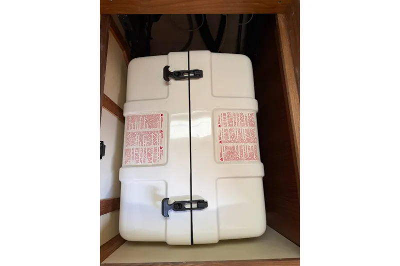 Slide: The Image of White storage container inside a wooden cabinet on a 2003 Hunter 44 Deck Salon yacht. - 60