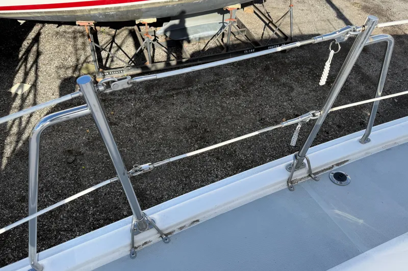 Slide: The Image of Stainless steel railing on 2003 Hunter 44 Deck Salon sailboat, docked on gravel. - 65