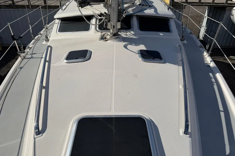 Slide: The Image of 2003 Hunter 44 Deck Salon sailboat deck with hatches and rigging. - 68