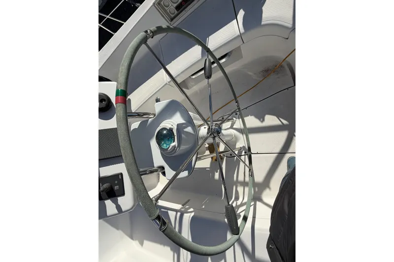 Slide: The Image of Steering wheel of 2003 Hunter 44 Deck Salon sailboat with compass and controls. - 70