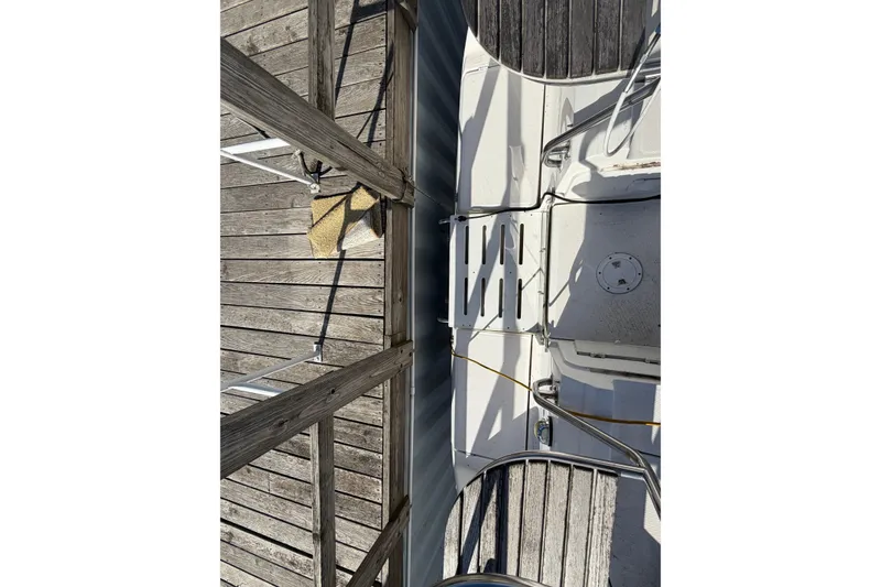 Slide: The Image of Top view of 2003 Hunter 44 Deck Salon yacht docked at wooden pier. - 71