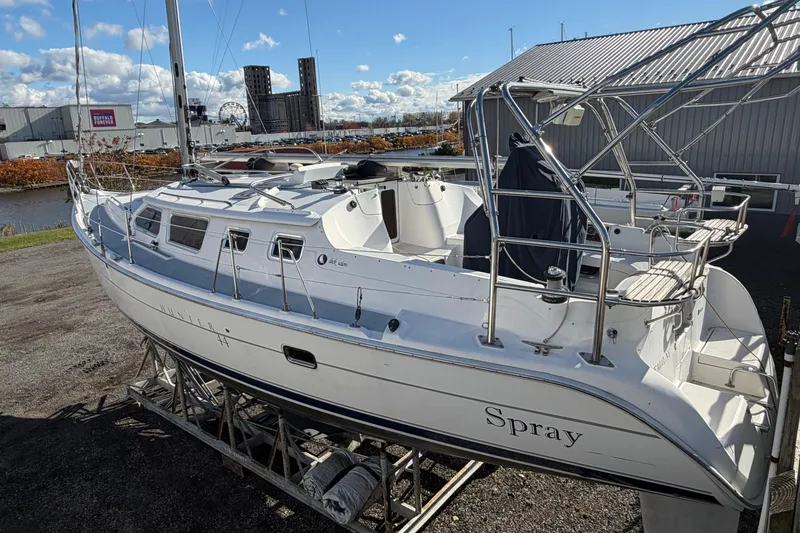 Slide: The Image of 2003 Hunter 44 Deck Salon sailboat named "Spray" on dry dock, sunny day. - 8
