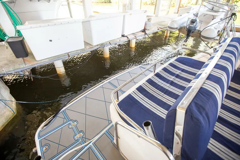 Slide: The Image of 2008 Regal 38 boat interior with striped seating, docked in a covered marina. - 19