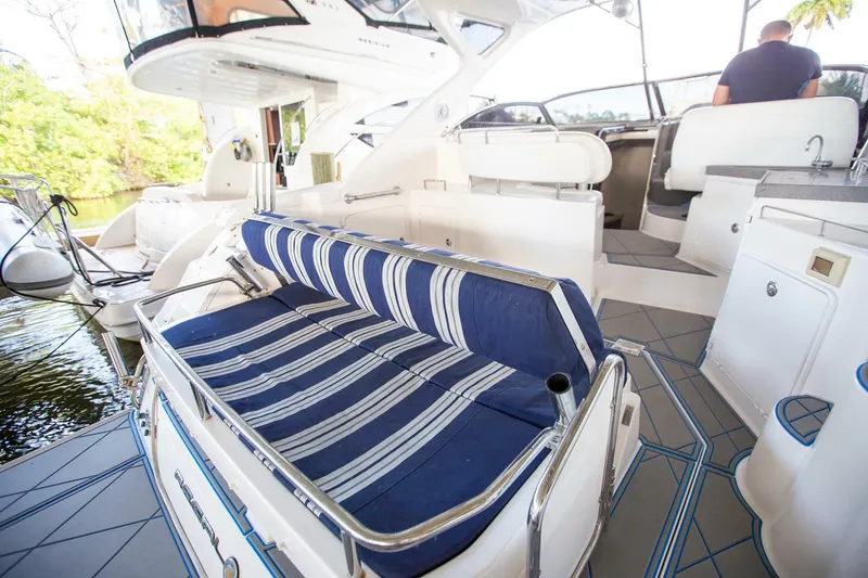 Slide: The Image of 2008 Regal 38 yacht interior with striped seating and modern amenities. - 21