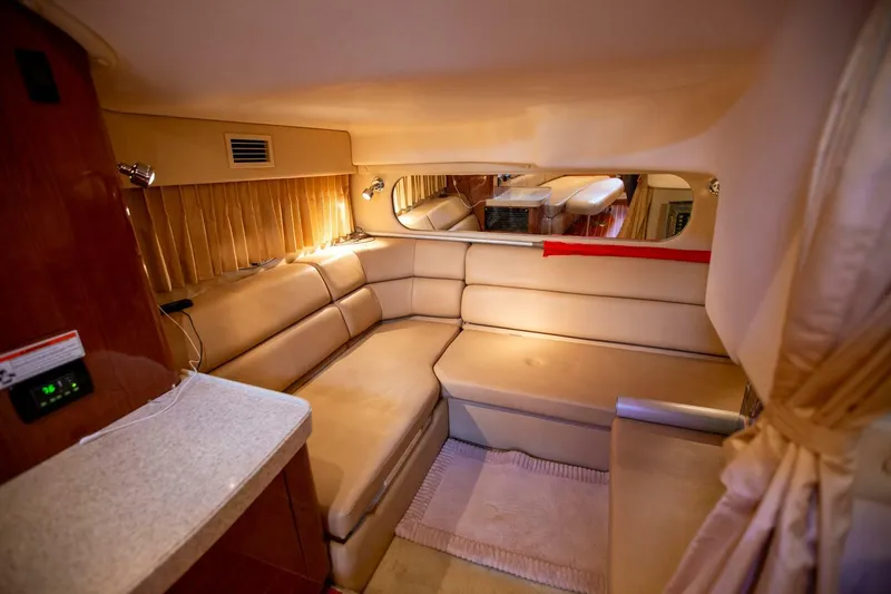 Slide: The Image of Luxurious interior of a 2008 Regal 38 yacht with beige seating and ambient lighting. - 5