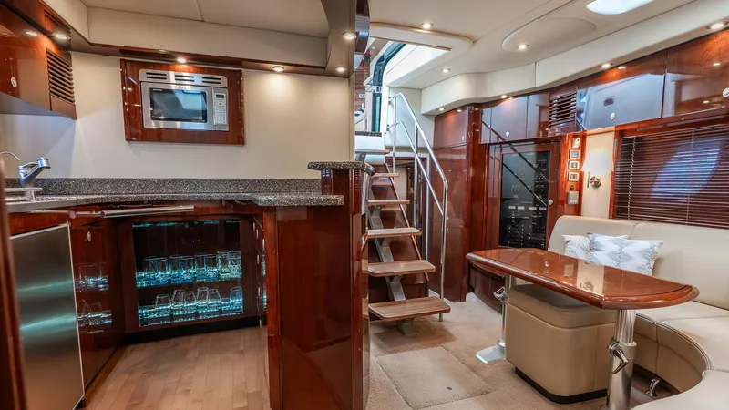 Slide: The Image of Luxurious interior of a 2008 Sea Ray Sundancer yacht with modern kitchen and seating area. - 15