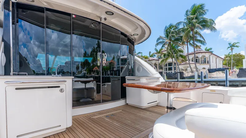 Slide: The Image of 2008 Sea Ray Sundancer yacht deck with seating, table, and waterfront view. - 26