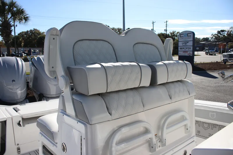 Slide: The Image of 2026 Sea Fox 282 Hybrid LT boat seating with diamond-stitched upholstery, outdoor dealership setting. - 10