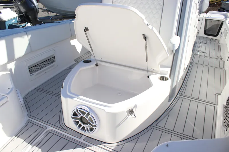 Slide: The Image of 2026 Sea Fox 282 Hybrid LT boat interior with open storage compartment and speaker. - 17