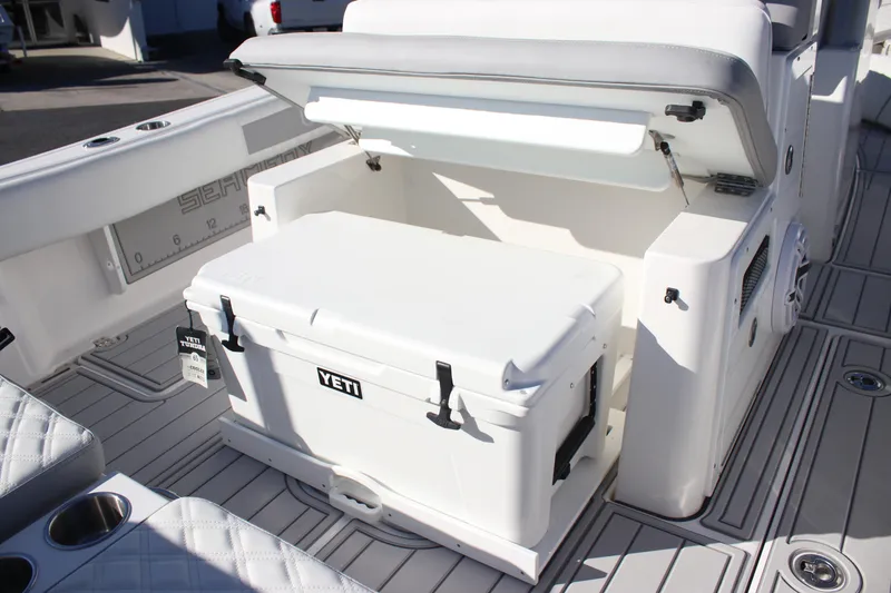 Slide: The Image of 2026 Sea Fox 282 Hybrid LT boat with Yeti cooler in storage compartment. - 22