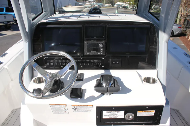 Slide: The Image of 2026 Sea Fox 282 Hybrid LT boat dashboard with steering wheel and navigation screens. - 27