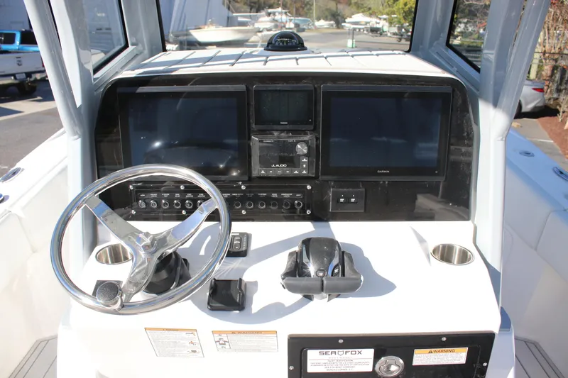 Slide: The Image of 2026 Sea Fox 282 Hybrid LT boat dashboard with steering wheel and navigation screens. - 28