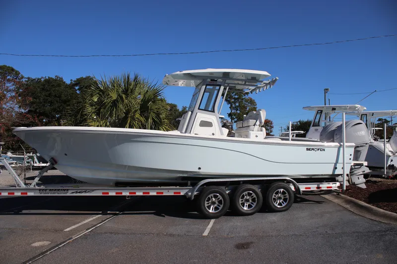 Slide: The Image of 2026 Sea Fox 282 Hybrid LT boat on a trailer, parked outdoors. - 3