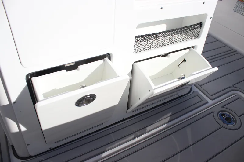 Slide: The Image of 2026 Sea Fox 282 Hybrid LT boat storage compartments with open drawers and netting. - 30