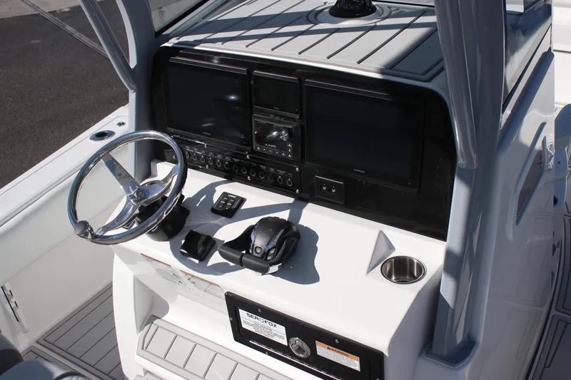 Slide: The Image of 2026 Sea Fox 282 Hybrid LT boat dashboard with steering wheel and electronic controls. - 8