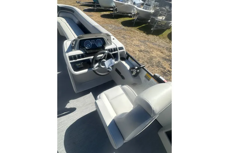 Slide: The Image of 2026 Godfrey Sweetwater 2286 Cruise Special Edition boat interior with modern dashboard and seating. - 13