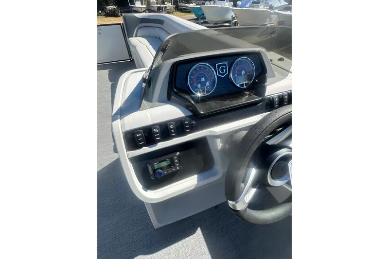 Slide: The Image of 2026 Godfrey Sweetwater 2286 Cruise dashboard with modern controls and steering wheel. - 14