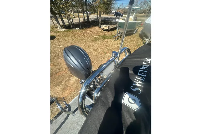 Slide: The Image of 2026 Godfrey Sweetwater 2286 Cruise Special Edition boat with cover and motor, outdoors. - 17