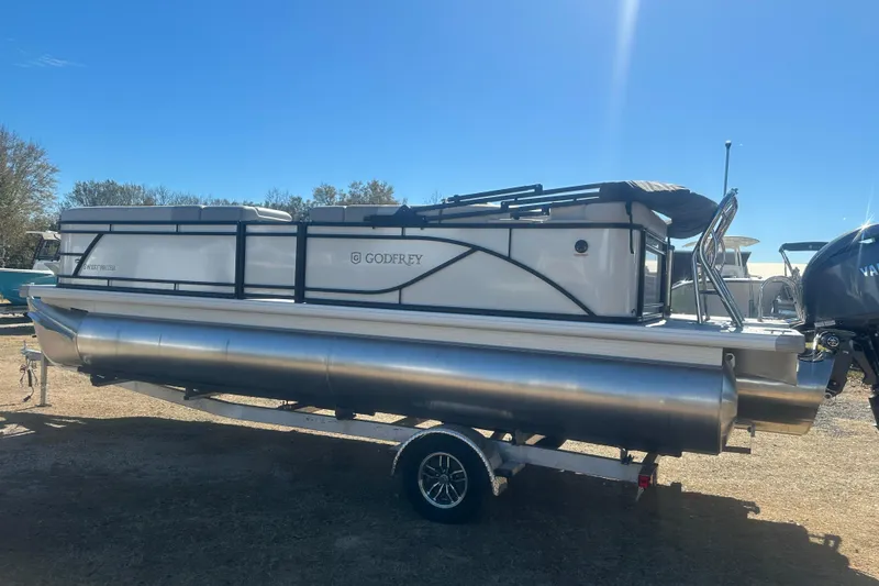 Slide: The Image of 2026 Godfrey Sweetwater 2286 Cruise Special Edition pontoon boat on trailer, sunny day. - 4