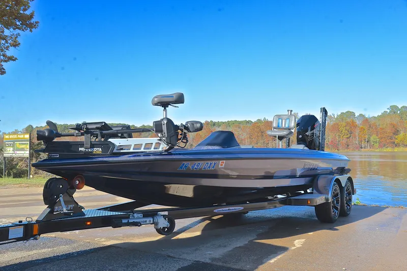 Slide: The Image of 2023 Bullet 21XRS boat on trailer by a lake, clear blue sky background. - 10