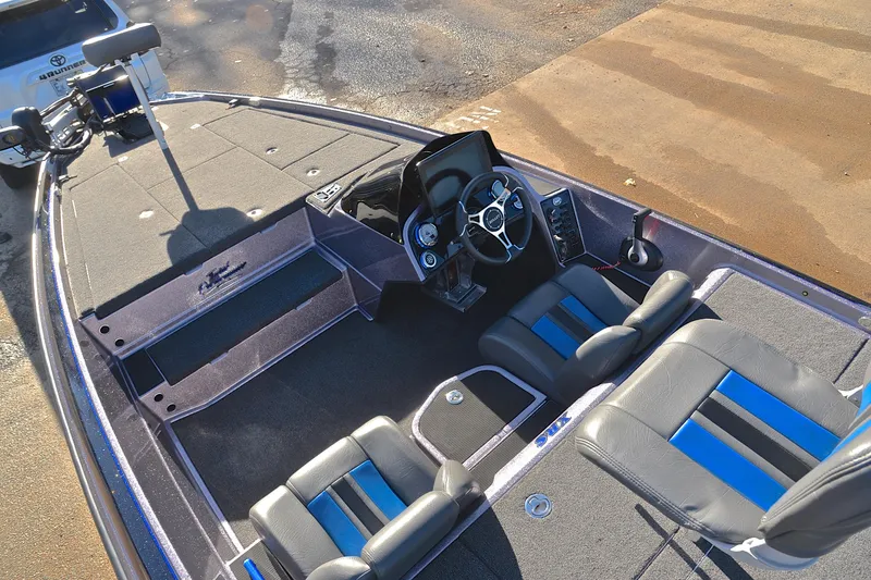Slide: The Image of 2023 Bullet 21XRS boat interior with steering wheel and seating. - 21
