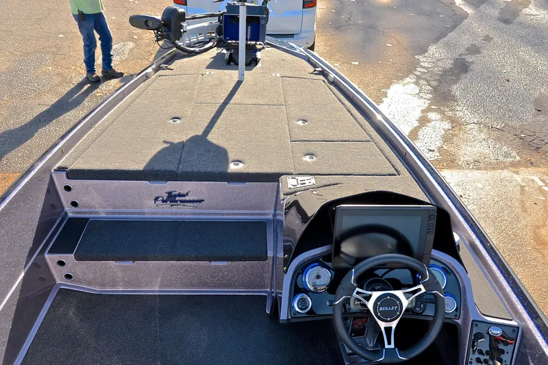 Slide: The Image of 2023 Bullet 21XRS boat interior with steering wheel and control panel. - 23